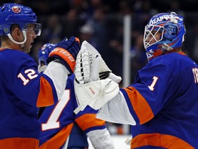New York Islanders goaltender Thomas Greiss (1) celebrates with right wing Josh Bailey (12) after defeating the Columbus Blue Jackets 2-0 in an NHL hockey game Monday, March 11, 2019, in Uniondale, N.Y.