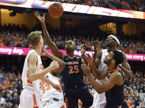 Virginia forward Mamadi Diakite (25) reaches for a rebound during the first half of an NCAA college basketball game against Syracuse in Syracuse, N.Y., Monday, March 4, 2019.