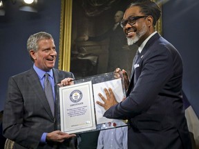 New York Mayor Bill de Blasio, left, awards N.Y. City Councilman Robert Cornegy, Jr. the Guinness World Record's tallest male politician, Wednesday March 27, 2019, at City Hall in New York.
