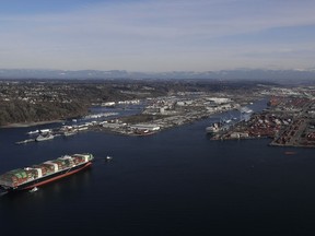 FILE- In this Tuesday, March 5, 2019, file photo the Cape Kortia container ship heads into the Port of Tacoma in Commencement Bay. The U.S. trade deficit jumped nearly 19 percent in December, pushing the trade imbalance for all of 2018 to widen to a decade-long high of $621 billion. The gap with China on goods widened to an all-time record of $419.2 billion.