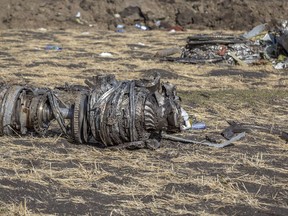 FILE- In this March 11, 2019, file photo airplane parts lie on the ground at the scene of an Ethiopian Airlines flight crash near Bishoftu, or Debre Zeit, south of Addis Ababa, Ethiopia. Investigators have determined that an anti-stall system automatically activated before the Ethiopian Airlines Boeing 737 Max jet plunged into the ground, The Wall Street Journal reported Friday, March 29.