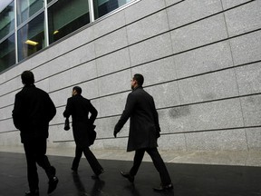 FILE- In this Jan. 17, 2012, file photo, pedestrians walk past the front of Goldman Sachs headquarters in New York. Business casual has become such an entrenched trend that even Goldman Sachs surrendered to it with a memo to employees announcing flexible dress code.