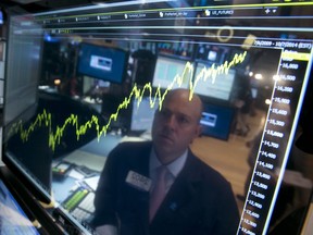 FILE - In this July 3, 2014, file photo, specialist Jay Woods is reflected in a screen at his post that shows five years of the Dow Jones industrial average, on the floor of the New York Stock Exchange. The biggest change over the last 10 years, many professional investors say is that index funds have become the default way for many to invest.