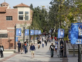 FILE - In this Feb. 26, 2015, file photo, students walk on the University of California, Los Angeles campus. Federal authorities have charged college coaches and others in a sweeping admissions bribery case in federal court. The racketeering conspiracy charges were unsealed Tuesday, March 12, 2019, against coaches at schools including UCLA, Wake Forest, Stanford, Georgetown, and the University of Southern California.