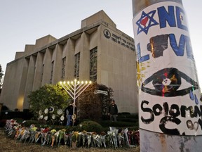 FILE - In this Dec. 2, 2018 photo, a menorah is tested outside the Tree of Life Synagogue in preparation for a celebration service at sundown on the first night of Hanukkah, in the Squirrel Hill neighborhood of Pittsburgh. A $6.3 million fund established in the wake of the Pittsburgh synagogue massacre will primarily be split among the families of the dead and survivors of the worst attack on Jews in U.S. history. The Jewish Federation of Greater Pittsburgh made the announcement Tuesday, March 5, 2019.