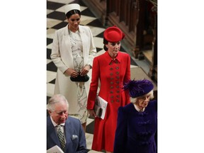 FILE - In this March 11, 2019 file photo, Britain's Kate, Duchess of Cambridge and Meghan, Duchess of Sussex leave after attending the Commonwealth Service at Westminster Abbey in London. With another royal baby on the horizon, the debate over postpartum perfection is alive and well. As it stands, we don't know whether Meghan Markle will follow in the footsteps of Kate Middleton when it comes to that magical perfection, but we have an inkling she'll at least slap on some makeup when she introduces the latest royal to the world next month.