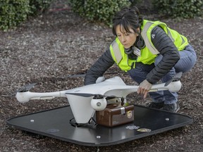 In this March 2019 photo provided by UPS, a drone operator handles a drone used for carrying medical specimens at a landing area at WakeMed hospital in Raleigh, N.C. UPS, Matternet and WakeMed announced a program on Tuesday, March 26, 2019, to use drones for commercial flights of blood samples and other medical specimens at the North Carolina hospital campus. (UPS via AP)