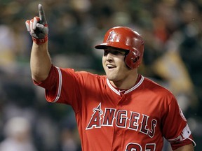 FIEL - In this April 3, 2017, file photo, Los Angeles Angels' Mike Trout celebrates after hitting a two-run home run off Oakland Athletics' Kendall Graveman in the third inning of a baseball game in Oakland, Calif. A person familiar with the negotiations tells The Associated Press Tuesday, March 19, 2019, that Trout and the Angels are close to finalizing a record $432 million, 12-year contract that would shatter the record for the largest deal in North American sports history.