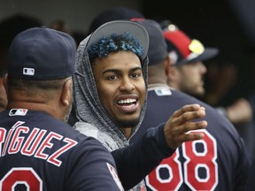 FILE - In this Monday, March 11, 2019, file photo, injured Cleveland Indians shortstop Francisco Lindor talks to a teammate in the dugout during the fourth inning of a spring training baseball game against the Cincinnati Reds in Goodyear, Ariz. Lindor will take a major step in his recovery from a calf strain by playing in a controlled minor league game.