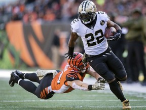 FILE - In this Nov. 11, 2018, file photo, New Orleans Saints running back Mark Ingram (22) outruns the tackle of Cincinnati Bengals defensive end Sam Hubbard (94) during the first half of an NFL football game in Cincinnati. The Baltimore Ravens finally made their move during the NFL's free agent frenzy, securing running back Mark Ingram and safety Earl Thomas on Wednesday, March 13, 2019.