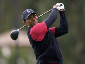 FILE - In this Feb. 17, 2019, file photo, Tiger Woods tees off on the 17th hole during the final round of the Genesis Open golf tournament at Riviera Country Club in the Pacific Palisades area of Los Angeles. Woods says a sore neck that kept him out of Bay Hill last week is no longer painful. Woods says his job is to make sure to stay fit and flexible. He used the word "pliable" three times during his news conference at The Players Championship.