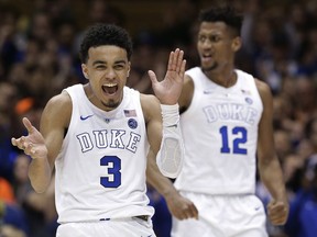 FILE - In this March 5, 2019, file photo, Duke's Tre Jones (3) and Javin DeLaurier (12) react following a play against Wake Forest during the second half of an NCAA college basketball game in Durham, N.C. Tyus Jones led a top-seeded Duke team to a national title four years ago. Now, younger brother Tre wants to do the same thing.