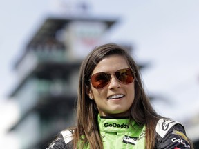 FILE - In this May 20, 2018, file photo, Danica Patrick waits during qualifications for the IndyCar Indianapolis 500 auto race at Indianapolis Motor Speedway in Indianapolis. Patrick, who retired from racing after last year's Indianapolis 500, will join NBC Sports' inaugural coverage of the Indianapolis 500 as a studio analyst alongside host Mike Tirico.