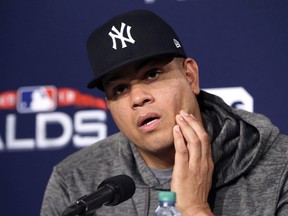 FILE - In this Oct. 4, 2018, file photo, New York Yankees pitcher Dellin Betances speaks to reporters during a baseball news conference at Fenway Park in Boston. Betances has inflammation in his right shoulder and will start the regular season on the injured list. New York general manager Brian Cashman said an MRI was done on Betances after the 6-8, 265-pound right-hander continued to lack velocity in his fastball.