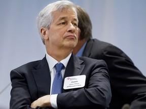 FILE - In this Dec. 3, 2014 file photo, JPMorgan Chase Chairman and CEO Jamie Dimon listens as President Barack Obama speaks to leading CEOs to discuss ways to promote the economy and create jobs during the president's last two years in office at the Business Roundtable Headquarters in Washington. The Business Roundtable, a lobbying organization of major companies' chief executives, said Wednesday, March 20, 2019 its first-quarter survey of CEOs showed strong support for Congress to create a new national law governing consumer data privacy.