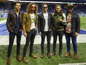 FILE - This Sept. 10, 2018 file photo shows members of the band LANCO on the field before a NFL football game between the Detroit Lions and the New York Jets in Detroit. The Academy of Country Music named LANCO as best new group of the year.  The group of five released their first album "Hallelujah Nights" last year on Arista Nashville.
