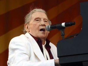 FILE - In this May 2, 2015 file photo, Jerry Lee Lewis performs at the New Orleans Jazz & Heritage Festival in New Orleans. Lewis has been transferred from a hospital to a rehabilitation center following a stroke last month, but will have to cancel upcoming shows, including his appearance at the New Orleans Jazz Festival. According to a statement from his neurologist released Monday,  March 18, 2019, the 83-year-old Lewis is expected to fully recover with aggressive and intensive rehab.