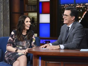 This Sept. 26, 2018 photo release by CBS shows New Zealand Prime Minister Jacinda Ardern, left, with host Stephen Colbert during a taping of "The Late Show with Stephen Colbert," in New York. Colbert has postponed what was supposed to be a surprise visit to New Zealand following the terrorist attack in Christchurch that killed 50 people. Colbert's The top-rated American late-night show said that he was supposed to travel to New Zealand on Wednesday for a week of shows. He was invited last fall when Ardern was a guest on the show.
