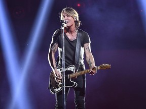 FILE - This Nov. 14, 2018 file photo shows Keith Urban performing at the 52nd annual CMA Awards in Nashville, Tenn. Urban will headline with The Killers and Foo Fighters at The Pilgrimage Music and Cultural Festival in Franklin, Tennessee, about 20 miles south of Nashville, on Sept. 21-22.