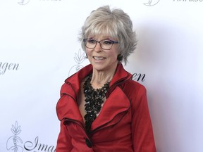 FILE - In this Aug. 25, 2018, file photo, Rita Moreno arrives at the 33rd annual Imagen Awards in Los Angeles. The Peabody Awards on Thursday announced it will honor the actress, singer and dancer with the career achievement award. That means the 87-year-old will join a handful of people who have achieved "PEGOT" status by winning a Peabody, Emmy, Grammy, Oscar and Tony award. Moreno will be honored at the Peabody's annual gala in New York City on May 18.