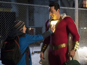 This image released by Warner Bros. shows Zachary Levi, right, and Jack Dylan Grazer in a scene from "Shazam!"