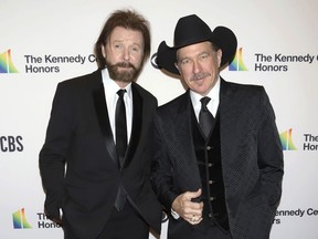 FILE - In this Dec. 2, 2018 file photo, Ronnie Dunn, left, and Kix Brooks attend the 41st Annual Kennedy Center Honors in Washington. Brooks & Dunn, comedic singer Ray Stevens and industry veteran Jerry Bradley will be inducted into the Country Music Hall of Fame later this year. The newest inductees were announced on Monday, March 18, 2019, in Nashville, Tennessee.