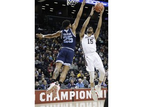St. Bonaventure's LaDarien Griffin (15) drives past Rhode Island's Christion Thompson (25) during the first half of an NCAA college basketball game in semifinal round of the Atlantic 10 men's tournament Saturday, March 16, 2019, in New York.