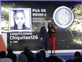 Chiquita Evans poses for photographs with Brendan Donohue after being selected as the 56th pick overall by the Warriors Gaming Squad at the NBA 2K League draft Tuesday, March 5, 2019, in New York. Evans is the first woman selected in the esports league.