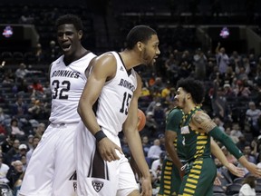St. Bonaventure's LaDarien Griffin (15) celebrates with teammate Amadi Ikpeze (32) during the first half of an NCAA college basketball game against the George Mason in the Atlantic 10 conference tournament Friday, March 15, 2019, in New York.