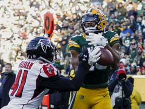 FILE - In this Dec. 9, 2018, file photo, Green Bay Packers' Randall Cobb catches a touchdown pass in front of Atlanta Falcons' Sharrod Neasman during the second half of an NFL football game in Green Bay, Wis. The Dallas Cowboys have agreed to terms on a one-year contract with free-agent receiver Cobb. He spent the first eight years of his NFL career with the Packers.