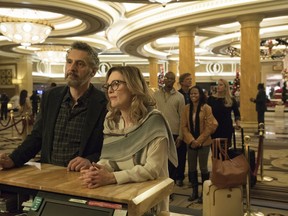 This image released by A24 shows John Torturro and Julianne Moore in a scene from "Gloria Bell." Everyone is vanishing around Julianne Moore's title character in Sebastian Lelio's "Gloria Bell." The disappearances don't come with blood-curdling shrieks or thundering score cues, but with the humdrum ebb of middle age. People just move away or recede from view.