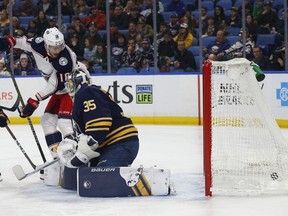 Buffalo Sabres goalie Linus Ullmark (35) is scored against by Columbus Blue Jackets forward Pierre-Luc Dubois (18) during the first period of an NHL hockey game Sunday, March 31, 2019, in Buffalo, N.Y.