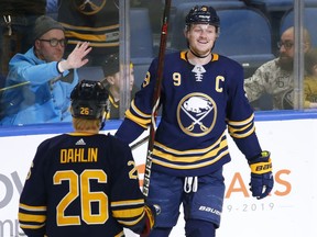 Buffalo Sabres defenseman Rasmus Dahlin (26) and forward Jack Eichel (9) celebrate a goal during the first period of an NHL hockey game against the Pittsburgh Penguins, Friday, March. 1, 2019, in Buffalo N.Y.