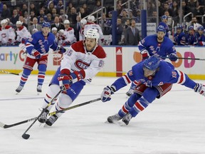 Montreal Canadiens right wing Andrew Shaw (65) controls the puck against New York Rangers defenseman Marc Staal (18) during the first period of an NHL hockey game, Friday, March 1, 2019, in New York.