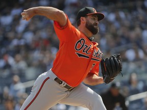 Baltimore Orioles starting pitcher Nate Karns delivers against the New York Yankees during the first inning of a baseball game, Saturday, March 30, 2019, in New York.