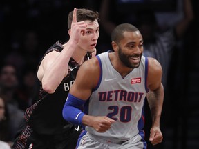 Brooklyn Nets forward Rodions Kurucs, left, reacts after scoring against the Detroit Pistons during the first quarter of an NBA basketball game, Monday, March 11, 2019, in New York.