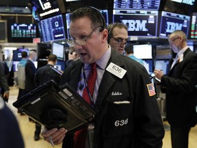 FILE- In this March 5, 2019, file photo trader Edward Curran, left, works on the floor of the New York Stock Exchange. The U.S. stock market opens at 9:30 a.m. EDT on Tuesday, March 12.