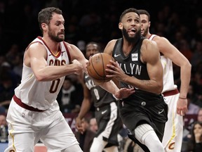 Cleveland Cavaliers forward Kevin Love (0) defends as Brooklyn Nets guard Allen Crabbe (33) drives to the basket during the first half of an NBA basketball game Wednesday, March 6, 2019, in New York.