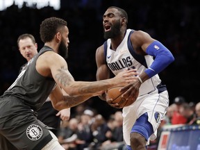 Brooklyn Nets guard Allen Crabbe, left,efends against Dallas Mavericks guard Tim Hardaway Jr., right, who prepares to go for a layup during the first half of an NBA basketball game, Monday, March 4, 2019, in New York.