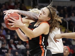 Oregon State guard Mikayla Pivec (0) battles for the ball with Louisville forward Sam Fuehring during the first half of a regional semifinal game in the NCAA women's college basketball tournament, Friday, March 29, 2019, in Albany, N.Y.