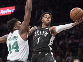 Brooklyn Nets guard D'Angelo Russell (1) goes to the basket against Boston Celtics center Robert Williams III (44) during the first half of an NBA basketball game, Saturday, March 30, 2019, in New York.