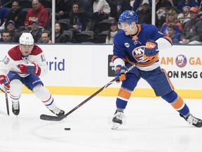 New York Islanders defenseman Ryan Pulock (6) skates against Montreal Canadiens center Max Domi (13) during the first period of an NHL hockey game, Thursday, March 14, 2019, in Uniondale, N.Y.