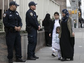 Worshippers arrive for service at the Islamic Cultural Center of New York under increased police security following the shooting in New Zealand, Friday, March 15, 2019, in New York.
