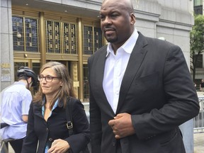 FILE -- In this Oct. 10, 2017 file photo, former Auburn University assistant men's basketball coach, Chuck Person, leaves Manhattan federal court in New York, after an initial appearance before a magistrate judge. Person is scheduled to plead guilty on Tuesday, March 19, 2019 to a conspiracy charge in a scandal that involved bribes paid to families of NBA-bound young athletes to steer them to top schools and favored money managers and agents.