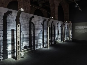 In this Feb. 13, 2018 photo provided by Musealia Entertainment SL, concrete posts topped with barbed and electrified wires from the Auschwitz concentration camp are shown while on exhibit in Madrid, Spain. The fence will be among hundreds of artifacts from Auschwitz displayed at New York's Museum of Jewish Heritage during an exhibit entitled "Auschwitz. Not long ago. Not far away," that opens to the public on May 8, 2019.  The exhibit, which includes a rail car like the ones used to transport prisoners to the camp, runs through Jan. 3, 2020.