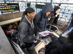 Brand ambassador Ayanna Whitmore distributes copies of a BuzzFeed newspaper at a subway station in New York's Union Square, Wednesday, March 6, 2019. The internet and social media company printed a one-time, special edition BuzzFeed newspaper, showcasing the latest news stories and BuzzFeed content.