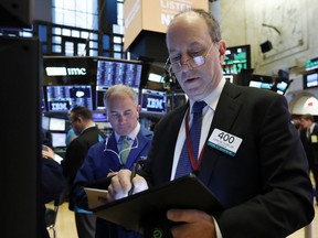 Trader Gordon Charlop, right, works on the floor of the New York Stock Exchange, Monday, March 18, 2019. Stocks are opening mostly higher on Wall Street, although a decline in Boeing is pushing the Dow Jones Industrial Average to a small loss.