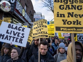 File-This April 5, 2018, file photo shows hundreds rallying  for a march to the 71st Precinct on Empire Boulevard to protest Wednesday's fatal police shooting of Saheed Vassell, a 34-year-old in the Crown Heights neighborhood of the Brooklyn borough of New York. Police officers were "legally justified" in the killing of a mentally disturbed man they said was wielding a piece of pipe like a gun on a New York City street, according to a report on the shooting released Friday, March 29, 2019. The review by the office of New York Attorney General Letitia James cleared New York Police Department officers who opened fired on Saheed Vassell in response to reports of an armed man menacing people on the streets of Brooklyn in 2018. "Based of a review of all the evidence ... the NYPD officers who shot Mr. Vassell were legally justified," the report concluded.