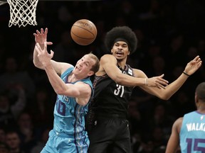 Brooklyn Nets' Jarrett Allen, right, blocks a shot by Charlotte Hornets' Cody Zeller during the first half of the NBA basketball game Friday, March 1, 2019, in New York.