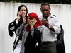 People wait outside a mosque following a mass shooting, in Christchurch, New Zealand, March 15, 2019.